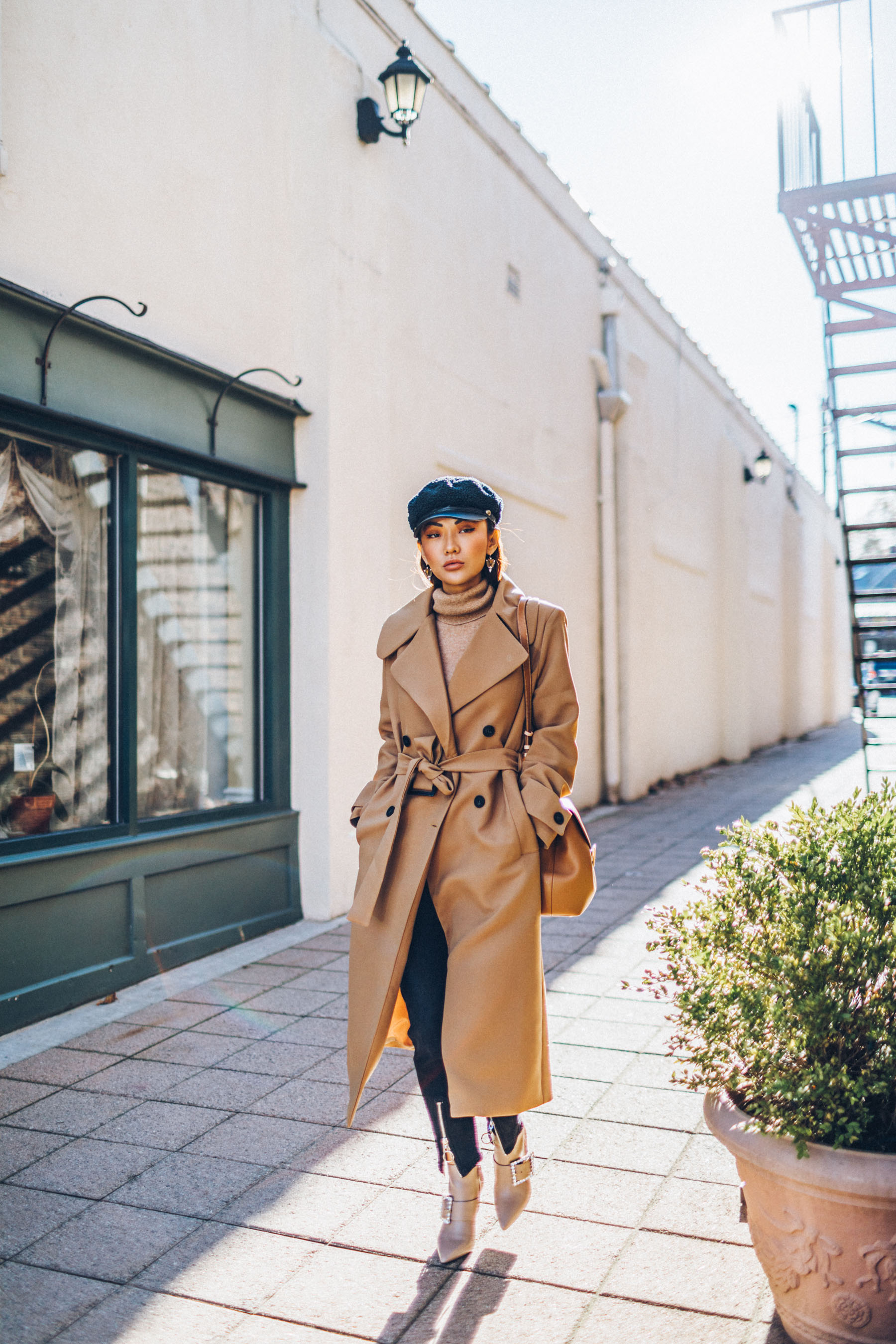 How to Buy an Investment Coat - Belted Camel Coat with Dark Denim Baker Boy Cap and Satchel // Notjessfashion.com // New York fashion blogger, asian blogger, classic camel coat, winter outfit, classic winter outfit, cozy layered outfut, nude boots, nude bag, baker boy hat, how to style camel coat, jessica wang, fashion blogger, street style, fashion blogger street style, oversized coat, duster coat, maxi coat