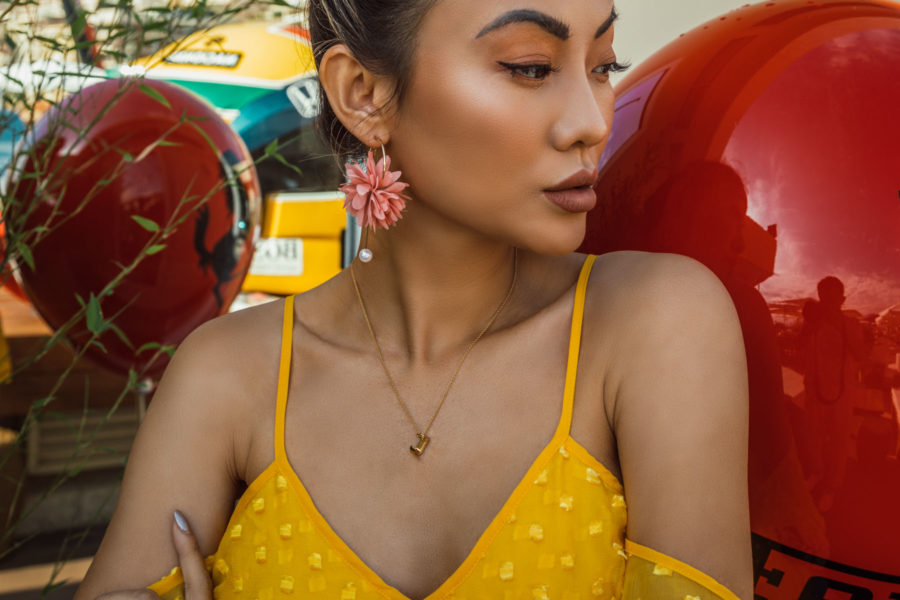 fashion blogger jessica wang wearing yellow jumpsuit and coral statement earrings // Notjessfashion.com