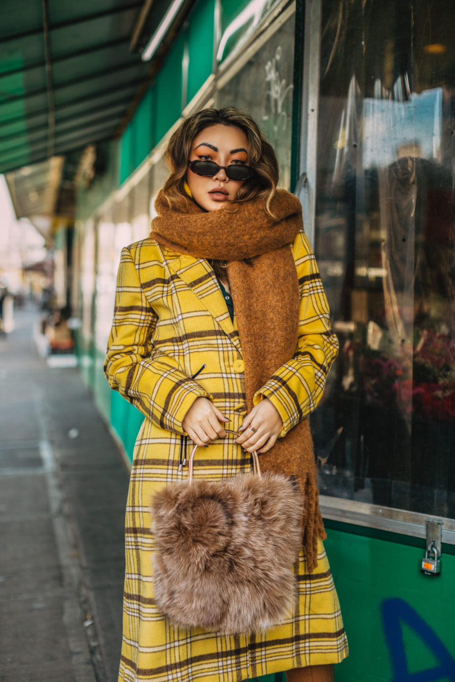 fashion blogger jessica wang wearing a chunky scarf and plaid coat while  sharing packing tips for a mini fall getaway // Jessica Wang - Notjessfashion.com