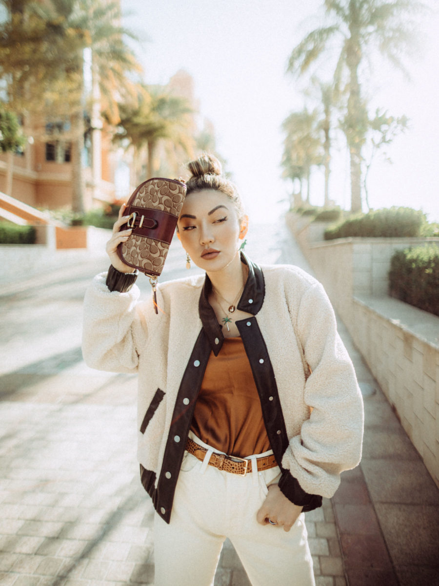 The fashion blogger jessica wang wears an all beige outfit with a shearling bomber and coach wallet // Notjessfashion.com