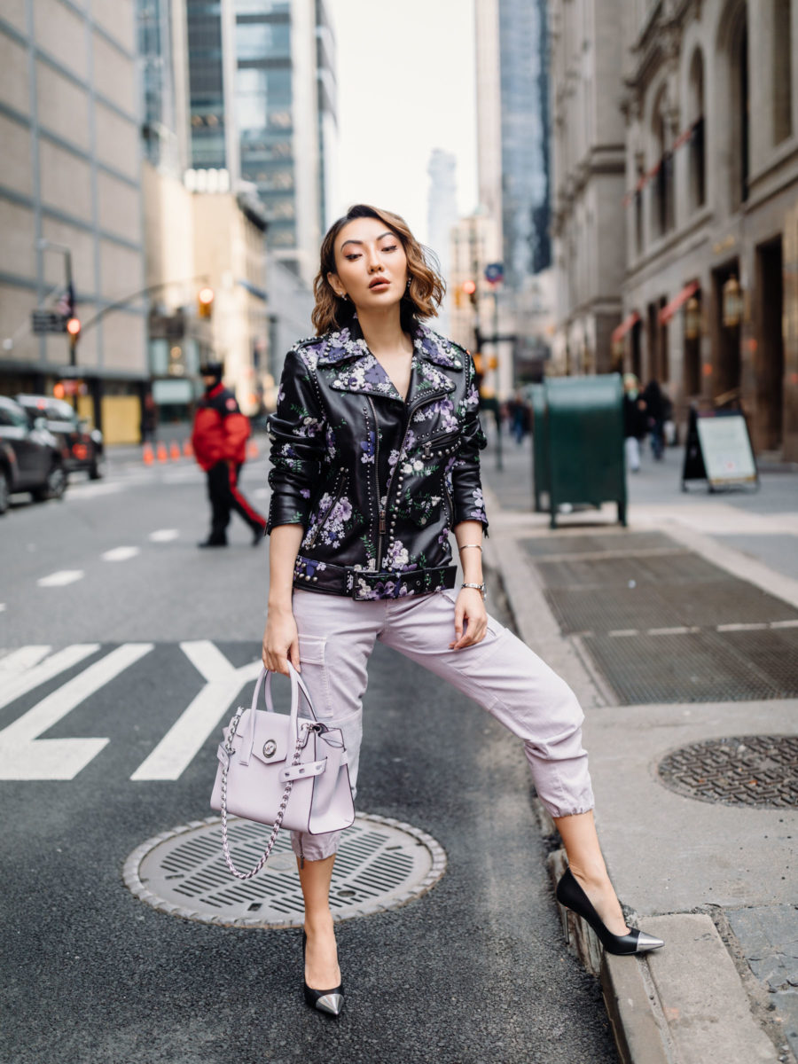 Jessica Wang wearing a studded leather moto jacket, lavender jogger pants, and two tone pumps with a michael kors satchel bag // Jessica Wang - Notjessfashion.com
