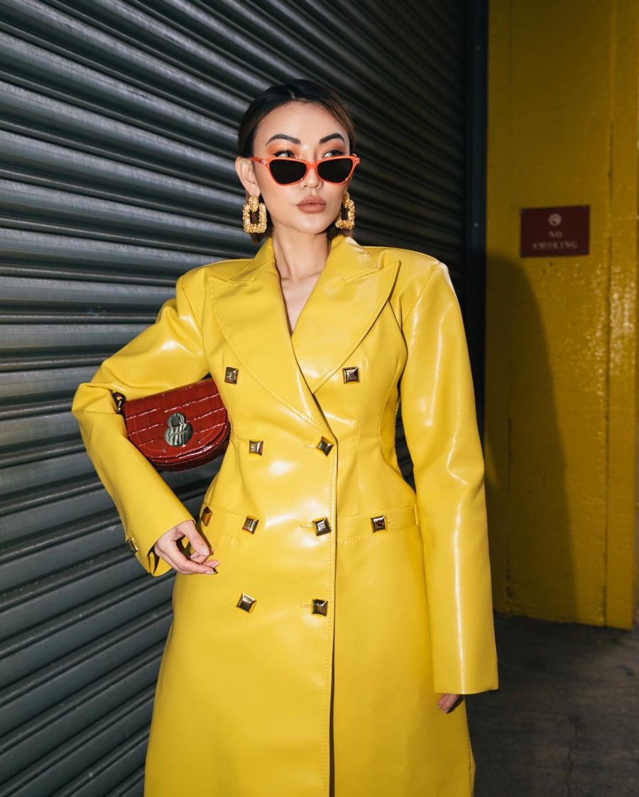 jessica wang wearing a faux leather yellow trench coat with colorful jewelry // Jessica Wang - Notjessfashion.com