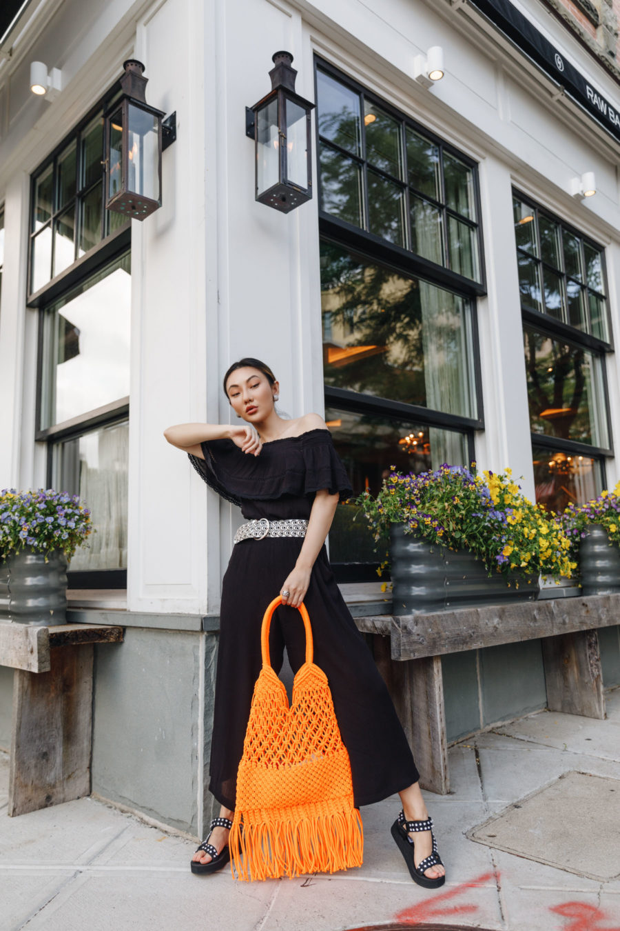 jessica wang wearing a black off the shoulder top with wide leg pants and a crochet fringe purse while sharing trendy handbags for summer // Jessica Wang - Notjessfashion.com