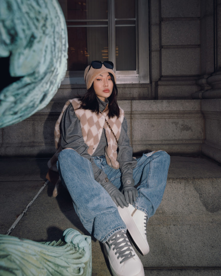 Jessica Wang wearing a printed sherpa vest with jeans while sharing tips on how to dress up jeans for winter // Jessica Wang - Notjessfashion.com