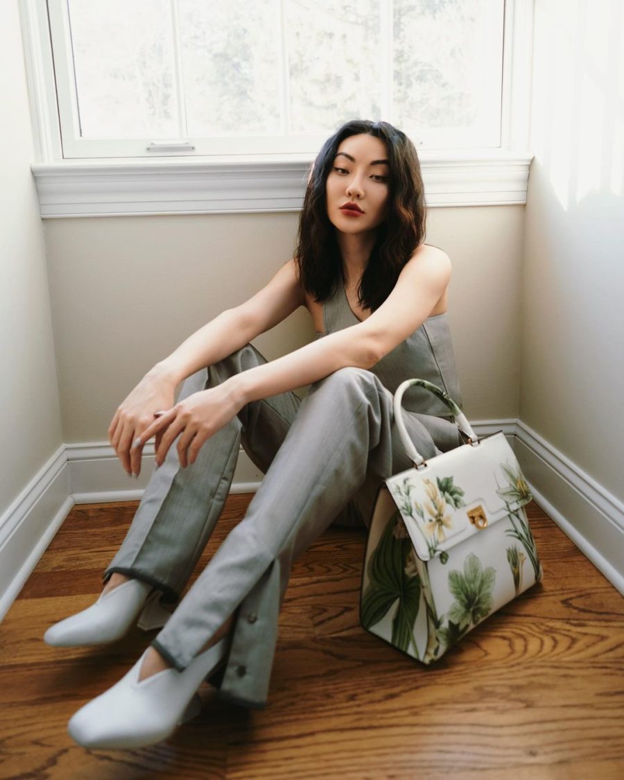 jessica wang wearing an assymetrical top with matching color pants and holding a floral print handbag while sharing trendy handbags for summer // Jessica Wang - Notjessfashion.com