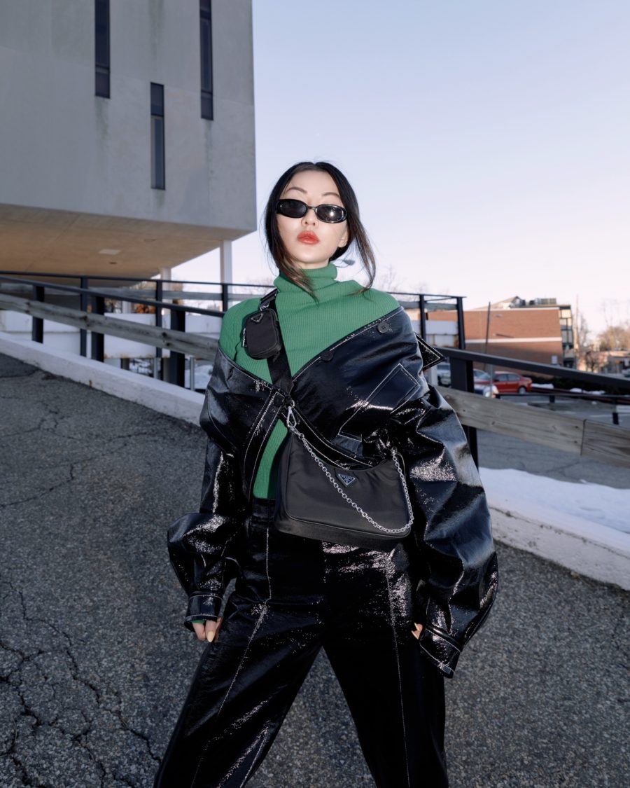jessica wang wearing a black patent jacket, a turtle neck knit sweater in green, leather pants and carrying a shoulder chain bag for a back to office outfit // Jessica Wang - Notjessfashion.com